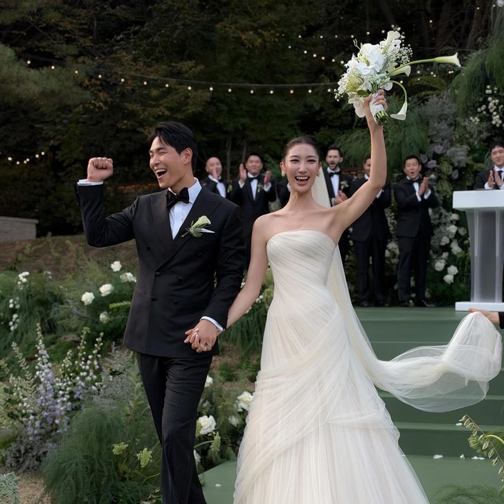 Korean American singer-songwriter Ejae, right, and music producer-composer Sam Kim pose in this wedding photo captured from Vogue's website Tuesday. Captured from Vogue